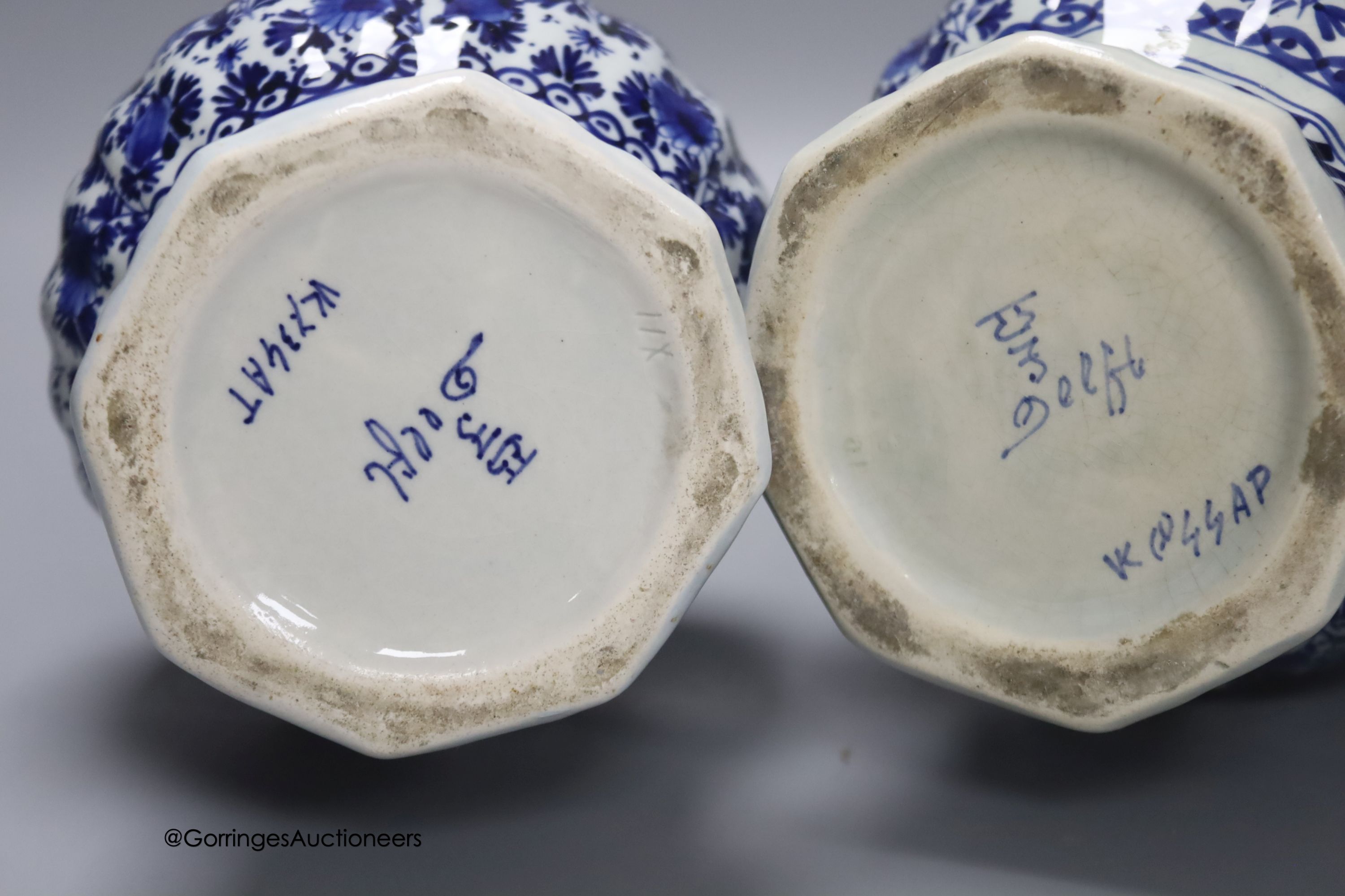 A pair of Dutch Delft blue and white vases, 29cm, a similar ovoid jar and cover and a bulbous jug